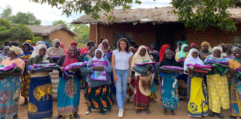 Young Servas member standing in a row of women in village